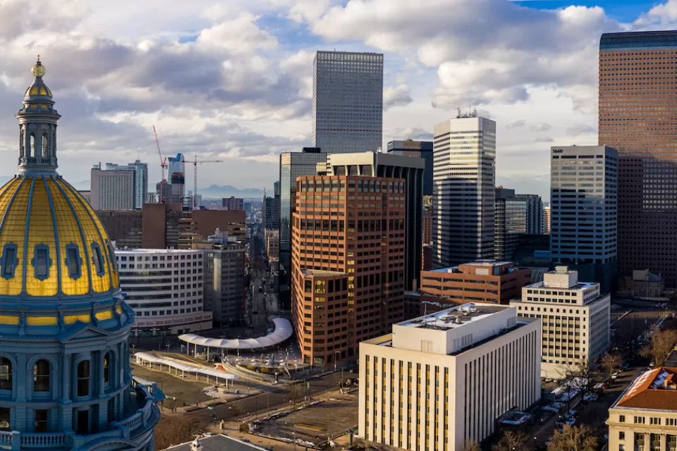 Aerial view of gold state capitol dome in Denver, Colorado and Denver skyline.